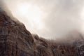 Winter storm clouds drift over the snow laced towering red sandstone cliffs of Zion national park Royalty Free Stock Photo