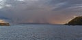 A Winter Storm outside Stonehaven Harbours Breakwater and Headland, catching the light of the setting sun