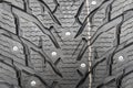 Winter studded tire background. Winter car tires texture background. Tire stack background. Tyre protector surface close up.