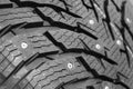 Winter studded tire background. Winter car tires texture background. Tire stack background. Tyre protector surface close up.