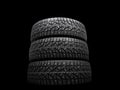 Winter studded tire. Winter car tires isolated on black background. Tire stack background. Tyre protector close up. Square Royalty Free Stock Photo