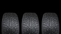 Winter studded tire. Winter car tires isolated on black background. Tire stack background. Tyre protector close up. Square Royalty Free Stock Photo