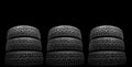 Winter studded tire. Winter car tires isolated on black background. Tire stack background. Tyre protector close up. Square Royalty Free Stock Photo