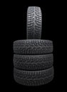 Winter studded tire. Winter car tires isolated on black background. Tire stack background. Tyre protector close up. Square Royalty Free Stock Photo