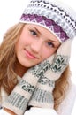 Winter style girl tenderly keeping hands near face