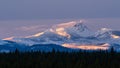 A winter sun sets over the Cascade Mountain Range in Oregon Royalty Free Stock Photo