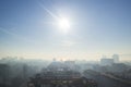 Winter sunny foggy morning over a seaside town. Bright sun shining through the haze on a seashore city. Soft focus landscape Royalty Free Stock Photo