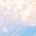 Winter sunny snow texture background with warm lens flare bokeh lights