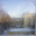 View of the old city house from a frozen winter window. Texture ice patterns on glass. Selective focus Royalty Free Stock Photo