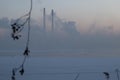 Winter sunrise over the lagoon with a view of the power plant immersed in fog