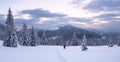 Winter sunrise panorama. A landscape of high mountains with a snow white peak. Forest. The lawn is covered with snow and the path Royalty Free Stock Photo