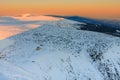 Winter, sunrise time, view from Snezka to Silesian house, krkonose mountains. Snezka is mountain on the border between Czech