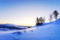 Winter sunrise on the top of the mountain a lot of snow and tree trunks Royalty Free Stock Photo