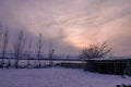 Winter sunset on a humble farmhouse