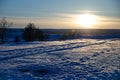 Winter sunset landscape with the frosty forest trees