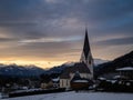 Winter sunset landscape of an old austrian church in an alps village, snowy mountains, Wallfahrtskirche Maria Schnee Matzelsdorf