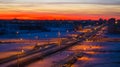 Winter sunset over the city street, houses, snow-covered road, wide angle Royalty Free Stock Photo