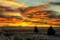 Winter sunset over a field with snow and haystacks Royalty Free Stock Photo