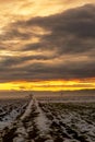 Winter sunset over a field with snow and haystacks Royalty Free Stock Photo