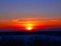 Winter sunset over a snowy field Royalty Free Stock Photo
