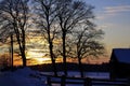 Winter, sunset over snowy landscape with hut and wooden fence, Bavaria, Germany Royalty Free Stock Photo