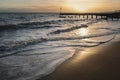 Winter sunset reflecting in the waves on the sandy Western Undercliff Beach in Ramsgate, Kent Royalty Free Stock Photo