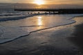 Winter sunset reflecting in the waves on the sandy Western Undercliff Beach in Ramsgate, Kent Royalty Free Stock Photo