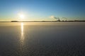 Winter sunset in Scandinavia, Low winter sun with rays reflecting in frozen lake Malaren, Chimneys of large power plant