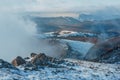 sunset snow field on top of mountain slope with frosty pine trees on the background of crimea forest and hills under grey Royalty Free Stock Photo