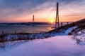 Winter sunset view with fresh snow and long cable-stayed bridge in Vladivostok, Russia