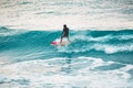 Winter surfing in ocean. Surfer on blue wave Royalty Free Stock Photo