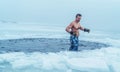 Winter swimming. Man in an ice-hole. Royalty Free Stock Photo