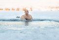 Winter swimming. Man to an ice-hole Royalty Free Stock Photo