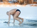 Winter swimming. Man to an ice-hole Royalty Free Stock Photo