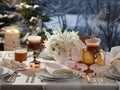Winter table setting with warm beverages and elegant flowers Royalty Free Stock Photo