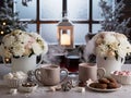 Winter table setting with warm beverages and elegant flowers Royalty Free Stock Photo