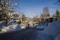 A winter tale - a sunny day for Christmas. Snow-covered streets, houses, sun rays, people walking along the pedestrian zone. ski