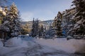 A winter tale - a sunny day for Christmas. Snow-covered streets, houses, sun rays, people walking along the pedestrian zone. ski