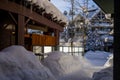 A winter tale - a sunny day for Christmas. Snow-covered streets, houses, sun rays, people walking along the pedestrian zone. ski