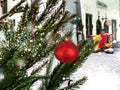 Winter Tallinn snowy Christmas tree decorated red ball   on medieval historical street in old town of Tallinn holiday in Estonia Royalty Free Stock Photo