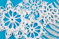 Winter theme white crochet snowflakes on light blue background.