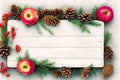 Winter themed background illustration with pine branches, needles, cones and red apples, with white painted weathered wooden board