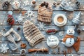 Winter-themed flat lay with knitted accessories, snowflakes, and hot beverage on wooden planks