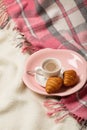 Winter time. A cozy warm pink blanket and a cup of coffee and cr