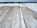 Winter fallow stubble agriculture field with snow, aerial