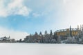 Winter time hotel skying resort apartment buildings frozen lake and forest white snowy season scenic environment with cloudy blue