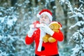 Winter time. Merry Christmas and happy holidays. Santa Claus blowing magic snow of his hands. Photo of Santa Claus Royalty Free Stock Photo