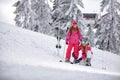 Winter time and skiing - mother preparing daughter on ski resort Royalty Free Stock Photo