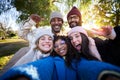 Winter time smiling selfie of a happy group of multicultural friends looking at the camera. Royalty Free Stock Photo