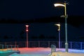 Winter time there are three lanterns with different color light on the alley near the fence Royalty Free Stock Photo